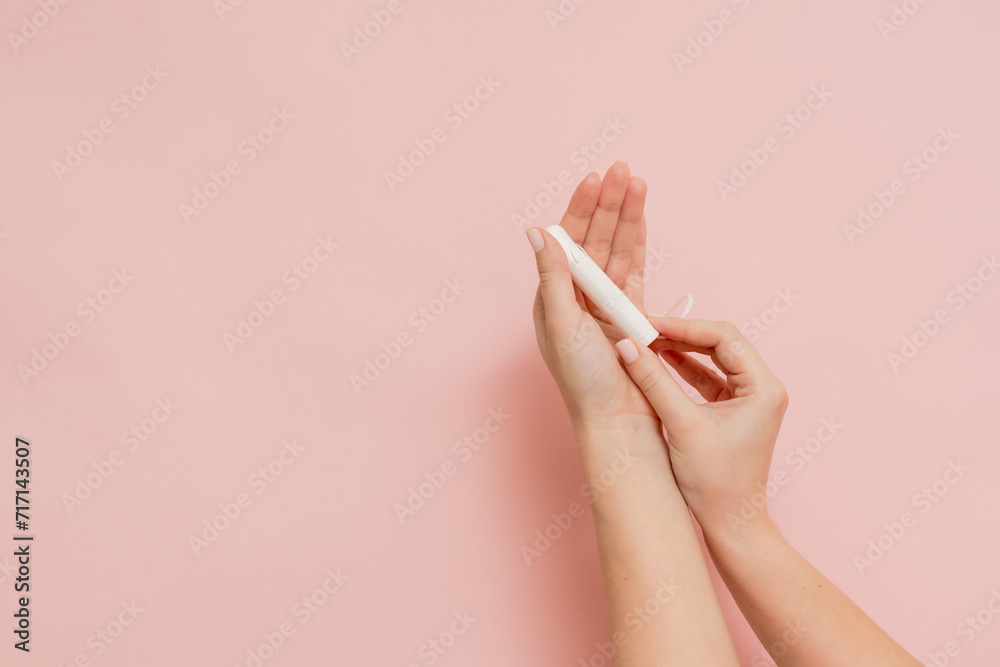 Medical feminine tampon in hand. Cotton swab. Menstruation - obrazy, fototapety, plakaty 