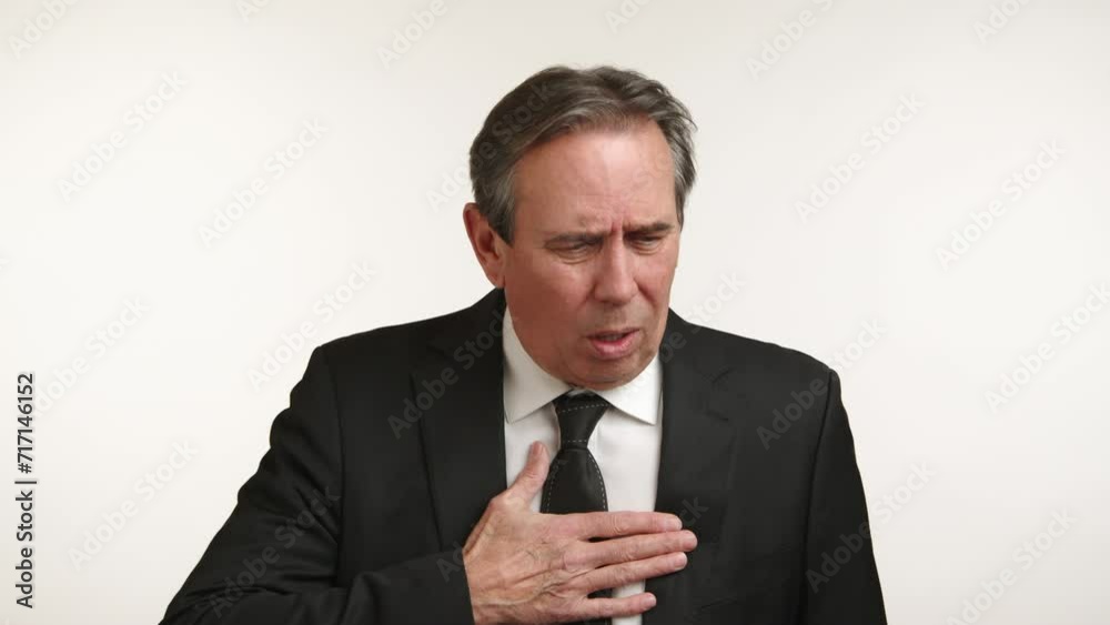 Distressed businessman in suit coughing or choking, concept of health issue at work. Distressed businessman in suit coughing or choking, concept of health issue at work.