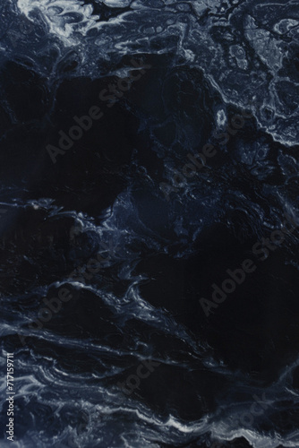 Marble blue background. Porcelain stoneware is dark blue. Ceramic tiles for finishing floor. Texture of stone slab. Graphic abstract background. Ceramic countertop.Vertical photo.