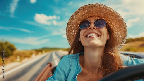 Joyful woman in a straw hat driving on a sunny day