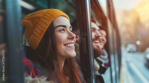 Smiling woman in a yellow beanie looking out of a bus window