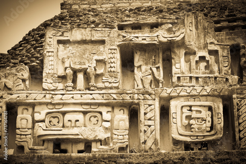 Sepia Tone Mayan ruins and stone carvings at the XUNANTINICH (Stone Lady) Mayan Temple in Belize Central America.  photo