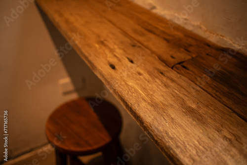 In a cozy café, adorned with rustic wooden tables and chairs, the charming ambiance is further enhanced