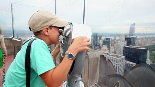 Boy looks in binocular viewer at Observation Deck Top photo