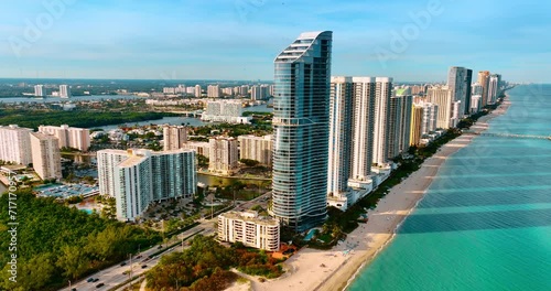 Approaching the row of skyscrapers on the shore of the Atlantic Ocean. Stunning view of Miami cityscape from top. photo