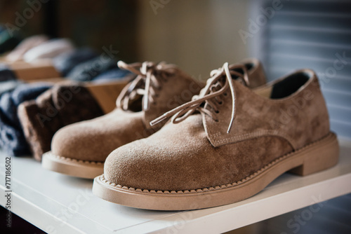 Suede shoes on sale in a retail shop. Fashion and shopping concept.