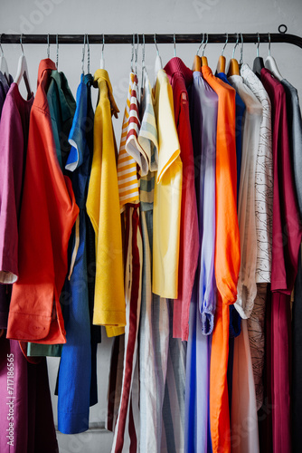 Colorful women's clothing on hangers in a retail shop. Fashion and shopping concept.