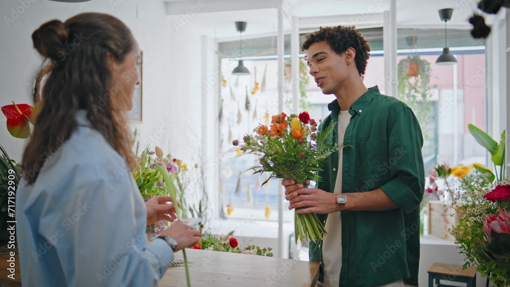 Smiling customer purchase flower composition in bouquet shop. Floristry concept. Smiling customer purchase flower composition in bouquet shop. Floristry concept.