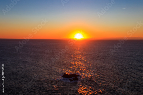 View of the Atlantic Ocean from Cabo da Roca at sunset. Cabo da Roca or Cape Roca is westernmost cape of mainland Portugal, continental Europe and the Eurasian land mass photo