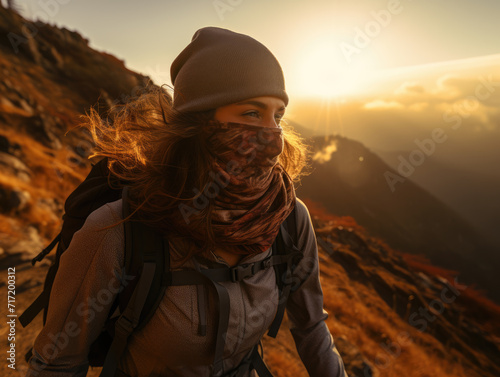 a young hiker wearing a breathable hiking face mask on a mountain trail 