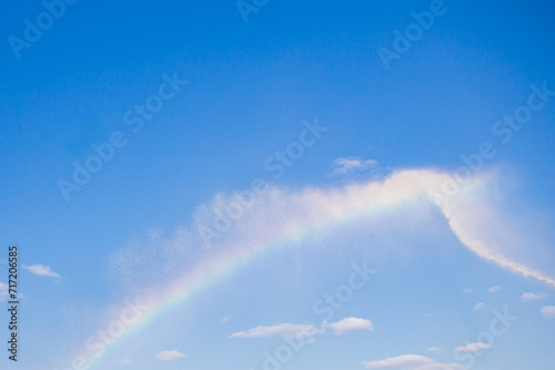 a rainbow appeared in the sky as a result of extinguishing a fire from a fire hydrant with a stream of water © Torkhov