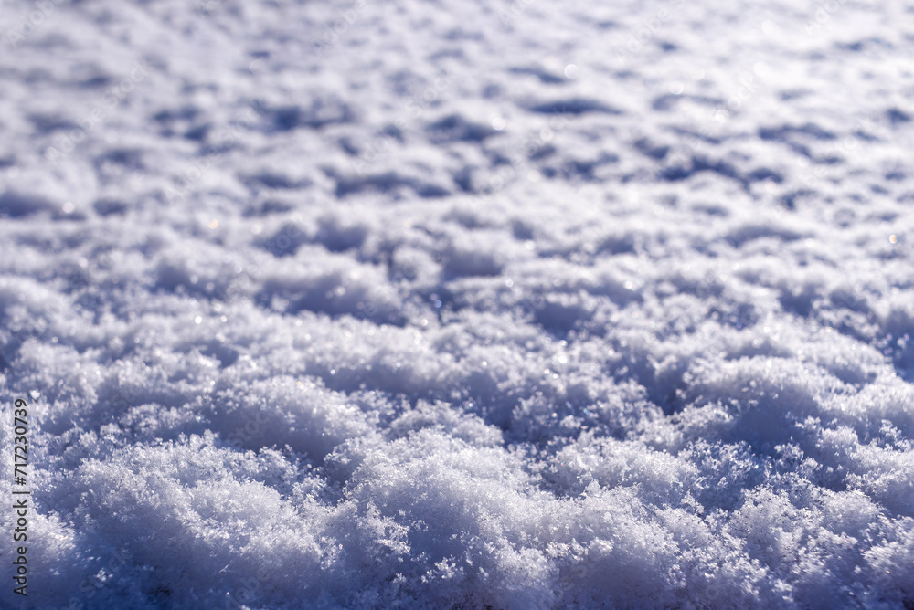 Texture of fresh, clean, sparkling, freshly fallen snow. Selective focus. Fallen snow sparkles in sun. Universal winter background