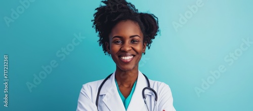 Young black woman doctor therapist showing fluorography shot in white coat, isolated on blue studio background. photo