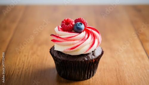 Chocolate cupcakes with cream cheese frosting and fresh berries