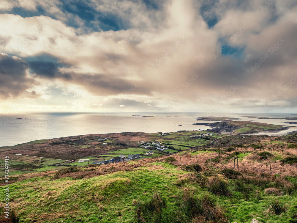 View on stunning nature scene from Sky road, near Clifden town in Connemara, county Galway, Ireland. Beautiful nature scene with ocean, hills and blue cloudy sky. Popular travel landmark.
