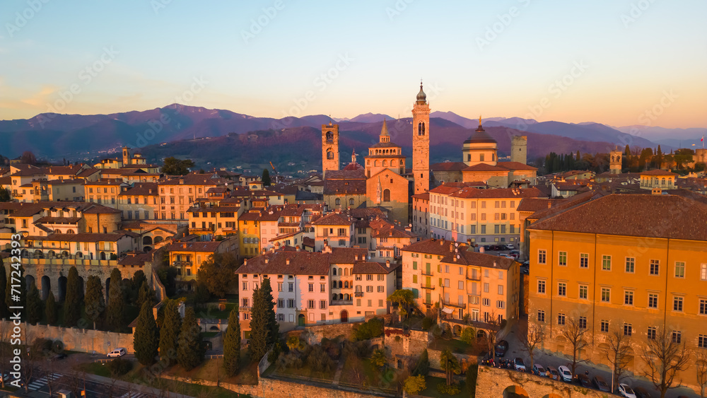 Fototapeta premium Citta Alta - Bergamo, Italy. Drone aerial view of the old town during sunrise. Landscape at the city center, its historical buildings. 