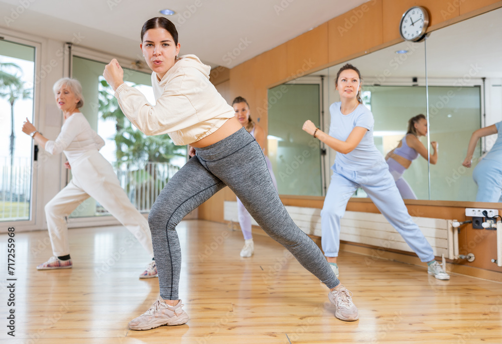 Obraz premium Group of different ages women enjoying active dance movement in modern studio