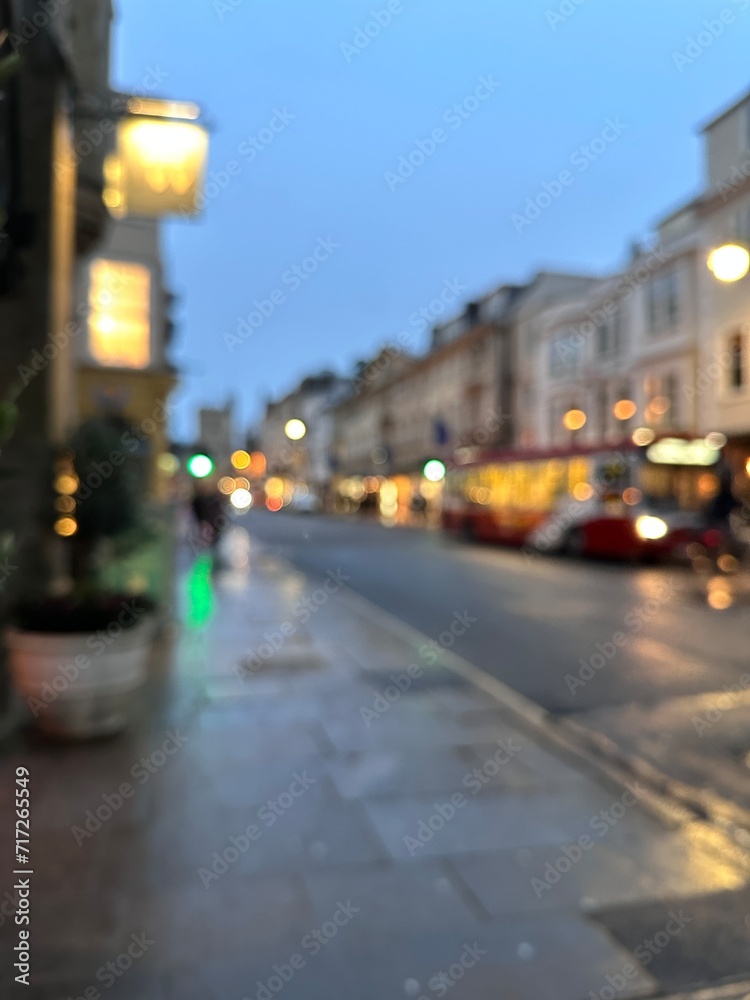 Cozy night lights of the city glowwing along the street, blurred background shot