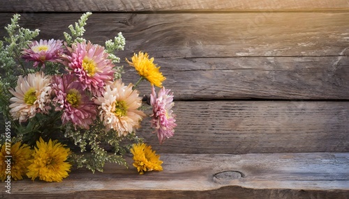 Autumn flowers on wooden background with copy space