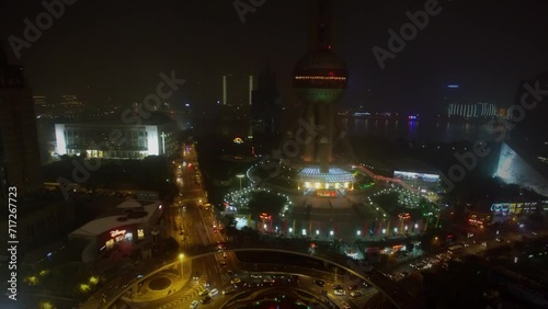 Road traffic on round square with pedestrian overpass and TV Tower photo