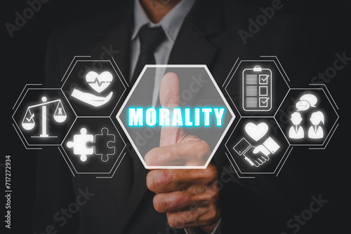 Morality concept. Businessman hand touching morality icon on virtual screen. ight, Ethics, Wrong, Behaviour, Philosophy, Society, Decision Making, Core Values.