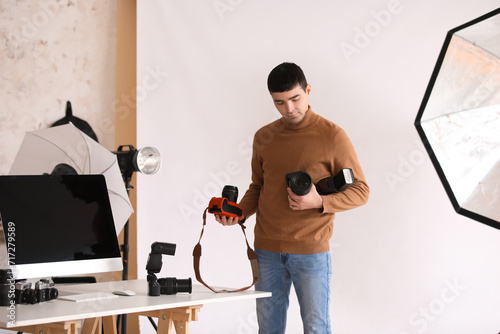 Young male photographer wit...