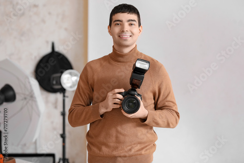Young male photographer wit...