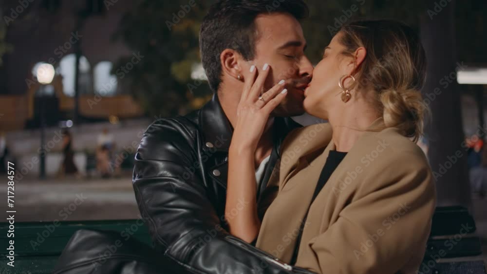 Engaged couple kissing city street closeup. Gentle man stroking looking woman Engaged couple kissing city street closeup. Gentle man stroking looking woman