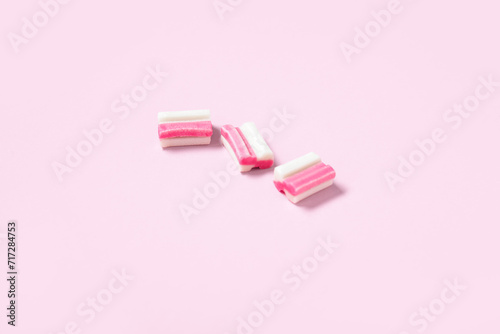 Tasty chewing gums on pink background