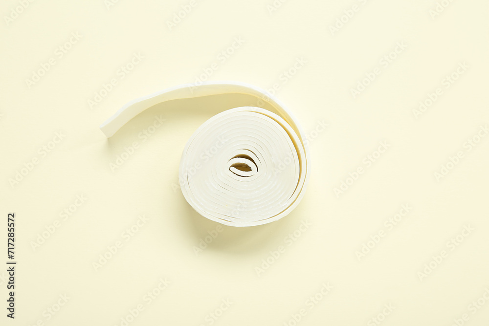 Twisted chewing gum on light yellow background