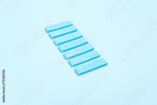 Color chewing gums on blue background