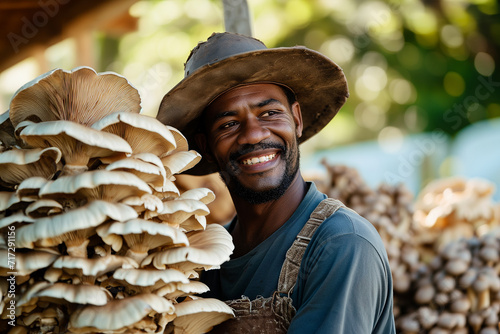 Happy African American farmer with oyster mushrooms