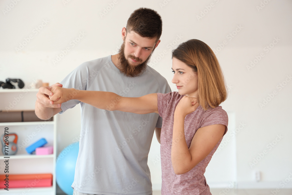 Instructor teaching young woman to fight in gym. Concept of self defense Instructor teaching young woman to fight in gym. Concept of self defense