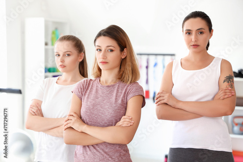 Portrait of young women in gym. Concept of self defense courses photo
