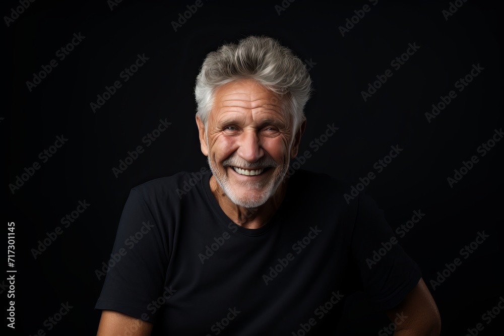 Portrait of a happy senior man on a black background. Studio shot. Portrait of a happy senior man on a black background. Studio shot.