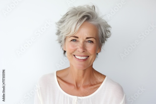 Portrait of a beautiful senior woman with grey hair smiling at the camera