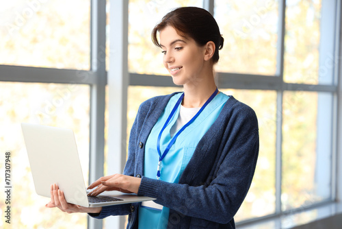 Female medical intern using laptop in hall Free Download Female medical intern using laptop in hall - GFXLoad