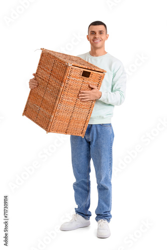 Young man carrying wicker b...