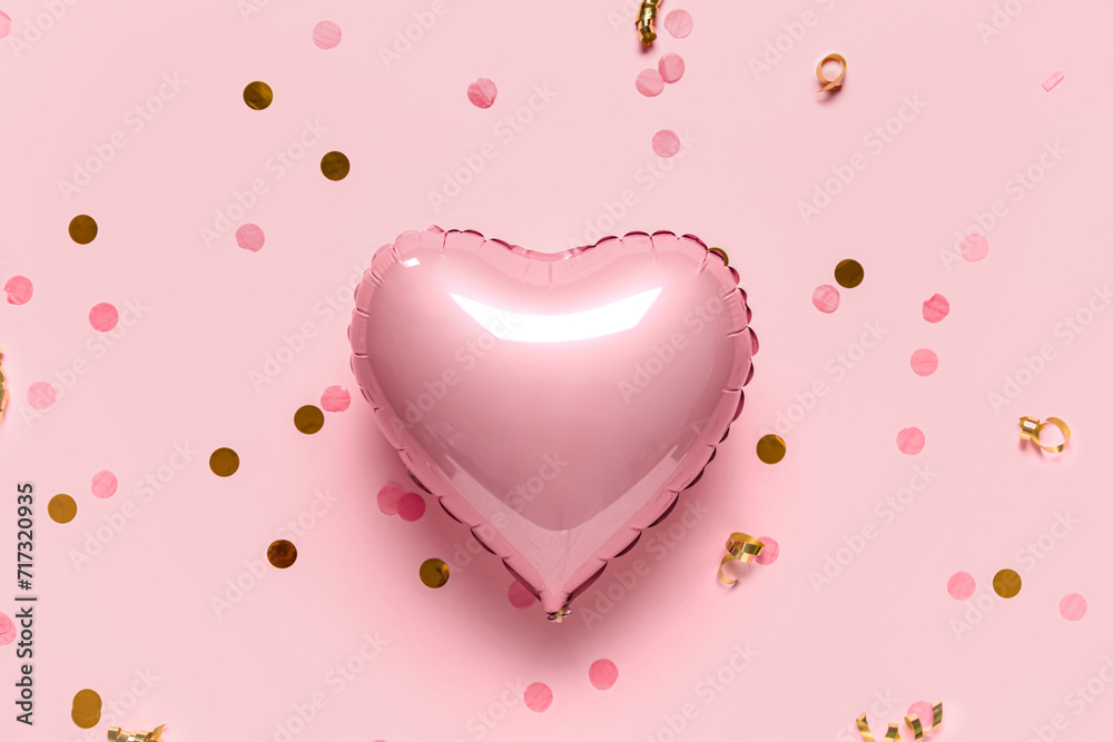 Heart shaped air balloon and confetti on pink background. Valentine's Day celebration