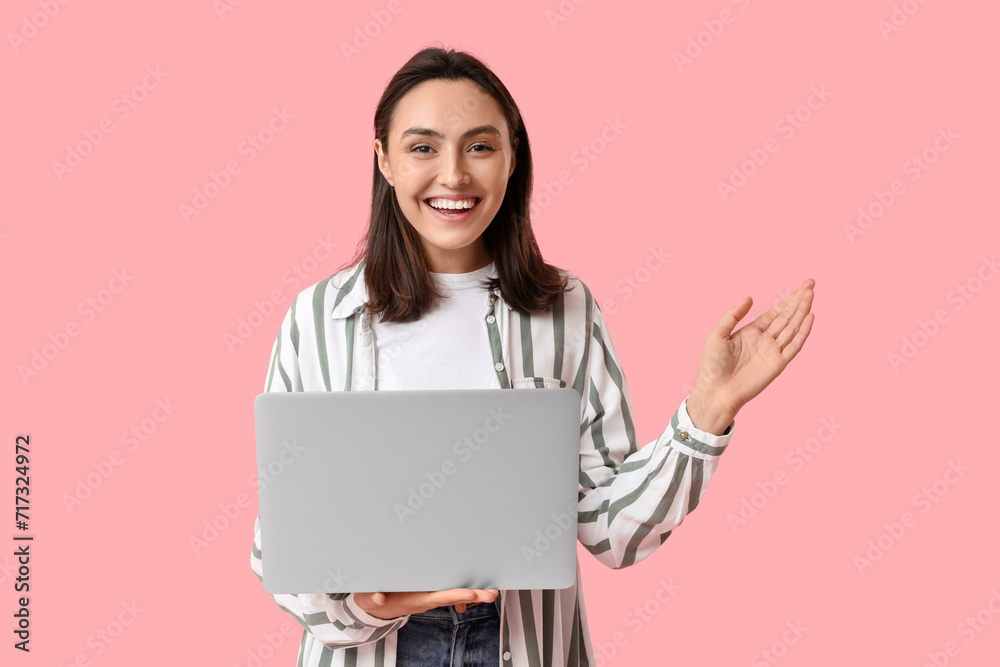 Pretty young woman with laptop on pink background Pretty young woman with laptop on pink background