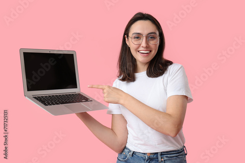 Pretty young woman pointing...