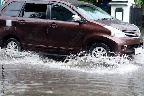 driving in puddles or flooded roads. driving risks aqua planing. © Andri