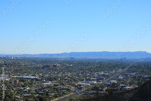 Late afternoon bluish haze over Arizona Capital City of Phoenix downtown under cloudless sky as seen from North Mountain Park toward South mountains © EuToch