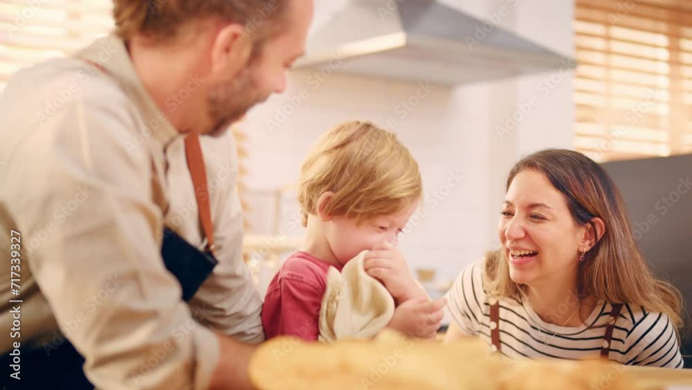 Caucasian attractive couple baking bakery with son in kitchen at home. Caucasian attractive couple baking bakery with son in kitchen at home.