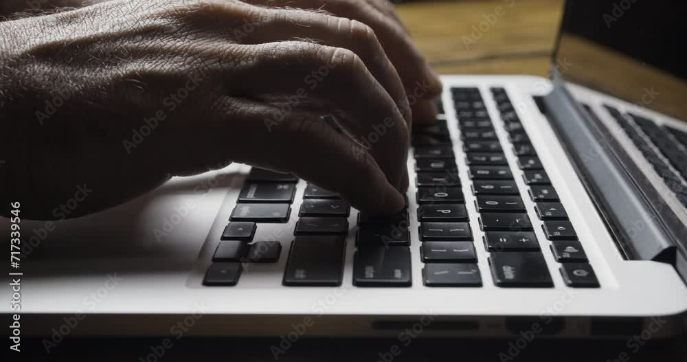 Caucasian Hands Enter Frame and Begin to Type on Silver Laptop Keyboard