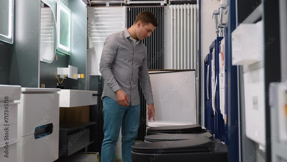 A man choosing home toilet in store A man choosing home toilet in store