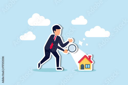 Searching for new house, look for real estate and accommodation valuation or new rent and mortgage concept, smart businessman using magnifying glass zooming to see house or residential details.