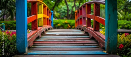 Colorful wooden bridge in a garden.