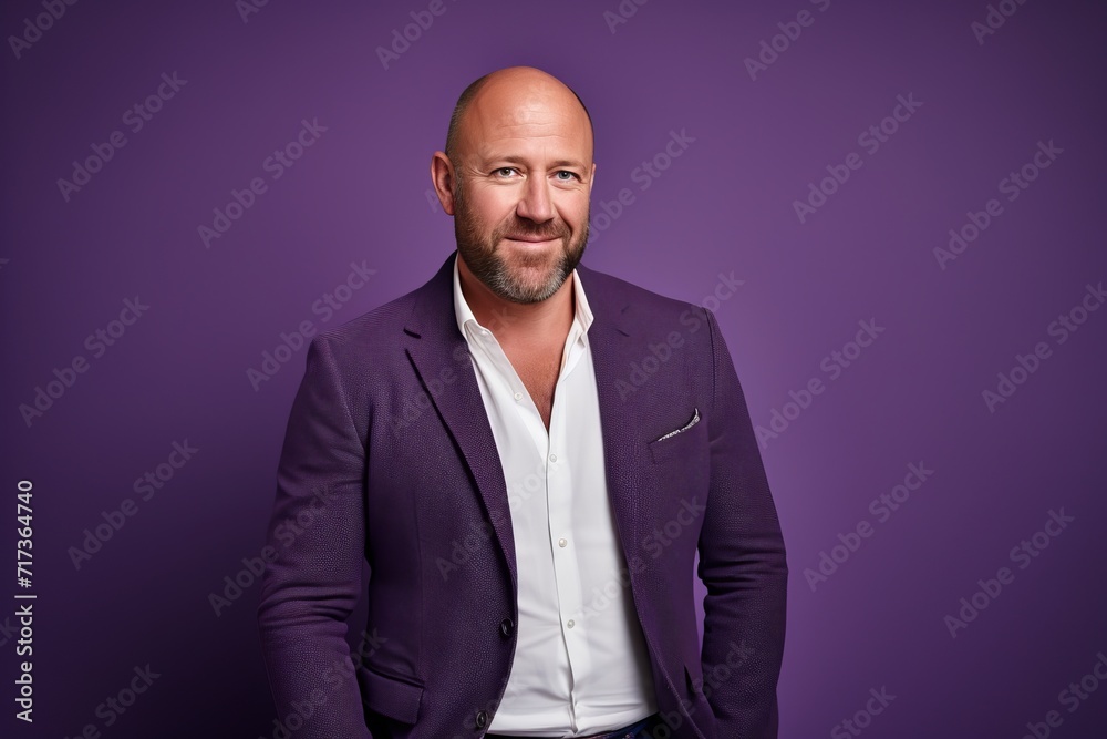 Portrait of a happy mature man in a suit on a purple background. Portrait of a happy mature man in a suit on a purple background.