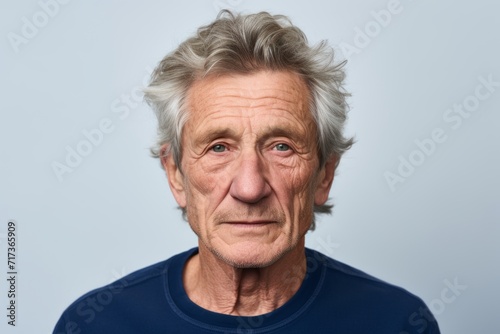 Portrait of a senior man with grey hair looking at the camera © Iigo
